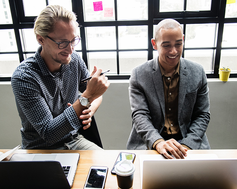 Businessman using laptop and smiling